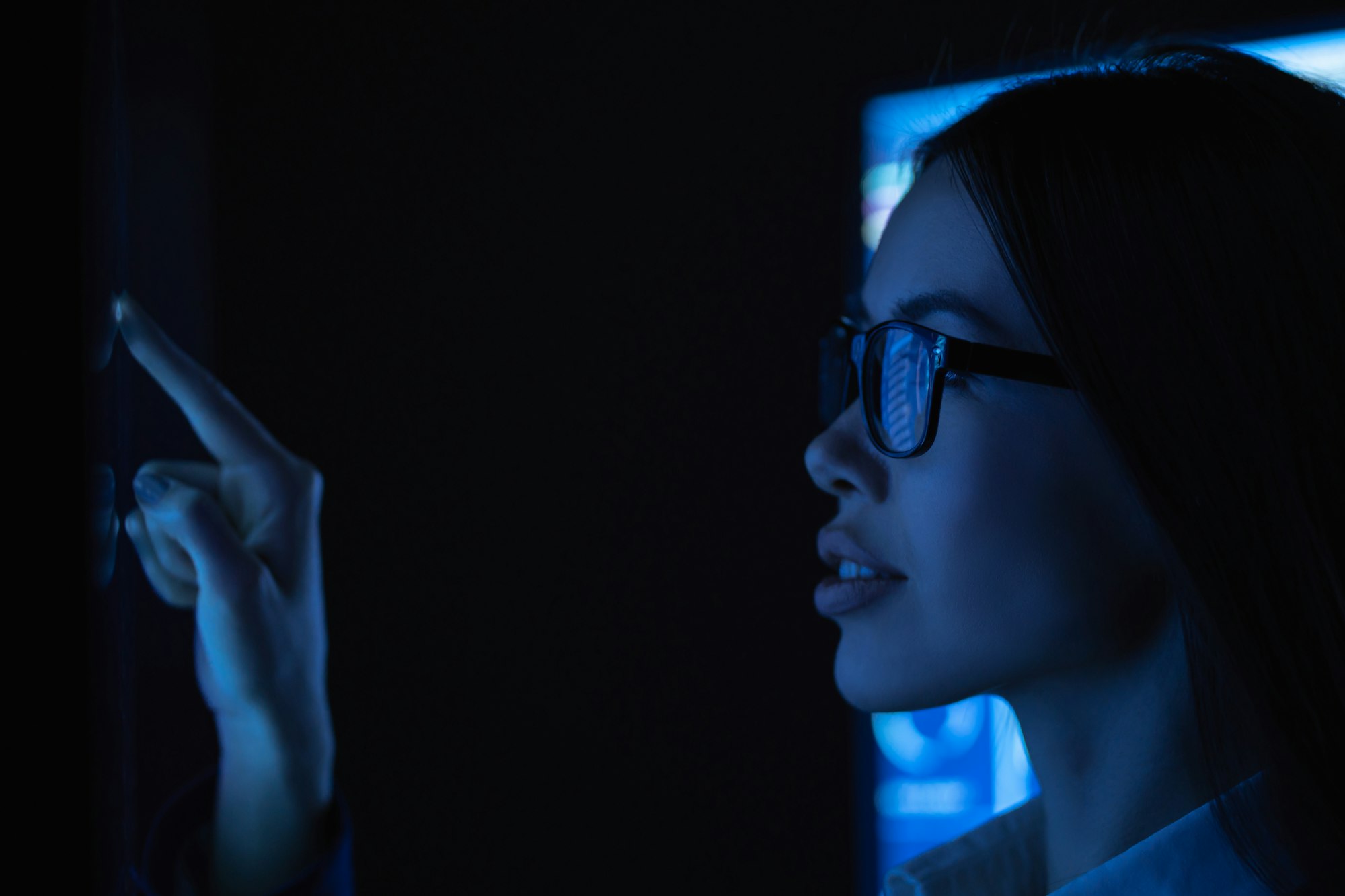 The young business woman touches sensor surface.